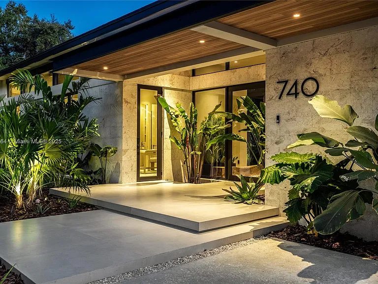 Lit entry of the finished modern home at 740 NE 120th St